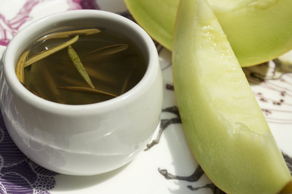 olive leaf tea with slice of melon