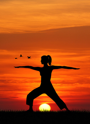 woman doing Yoga at sunset