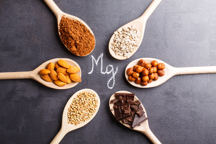 Products rich in magnesium on wooden spoons.