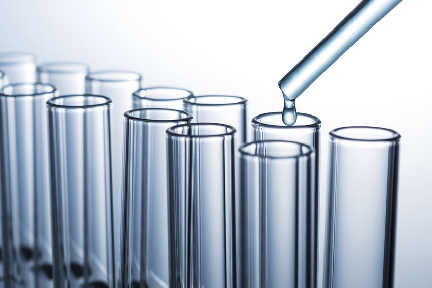 test tubes in a row on grey background